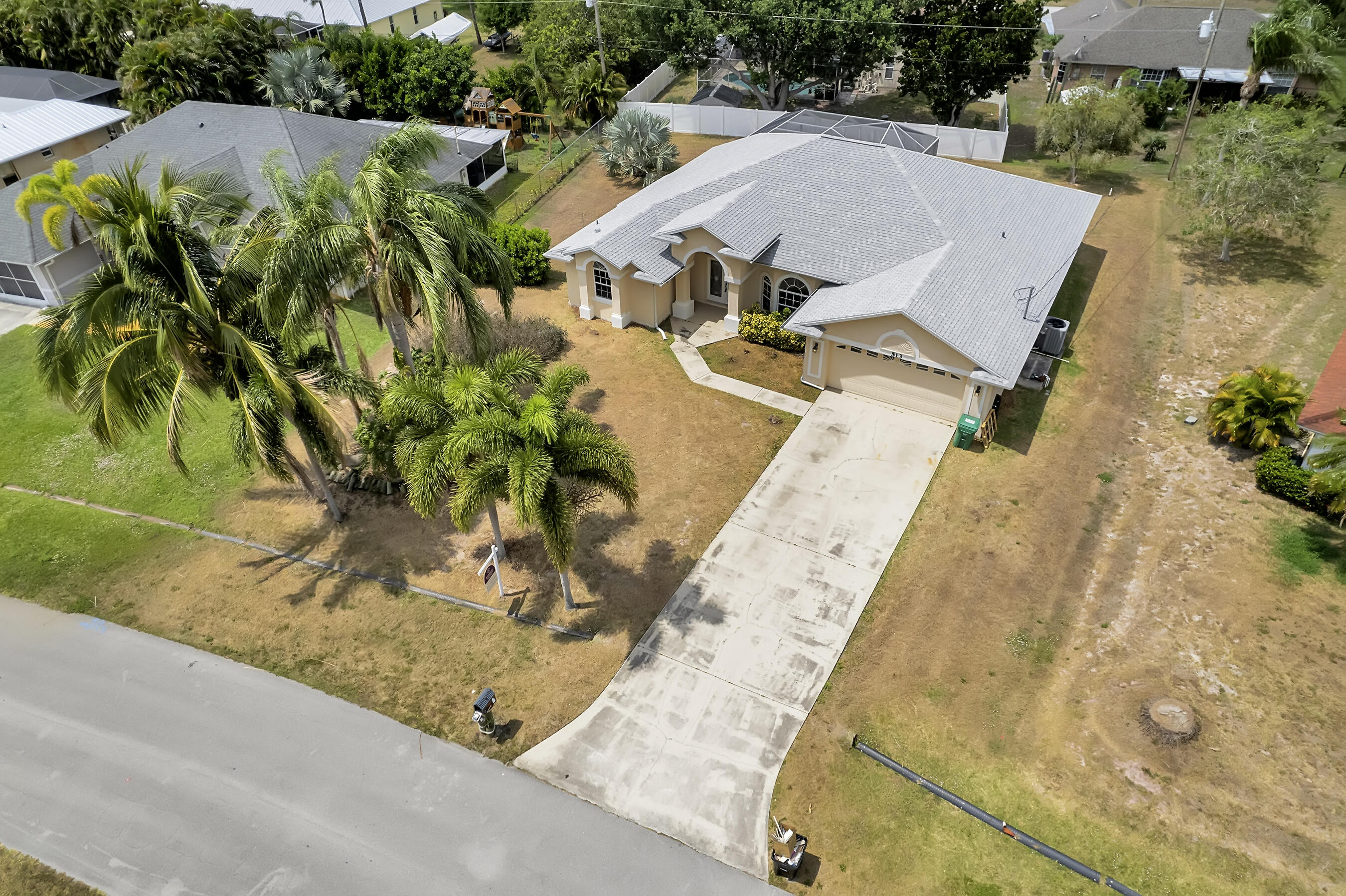 513 Southeast Cliff Road Port St. Lucie, FL 34984 - Photo 35 of 39 an aerial view of a house with a yard and sitting area