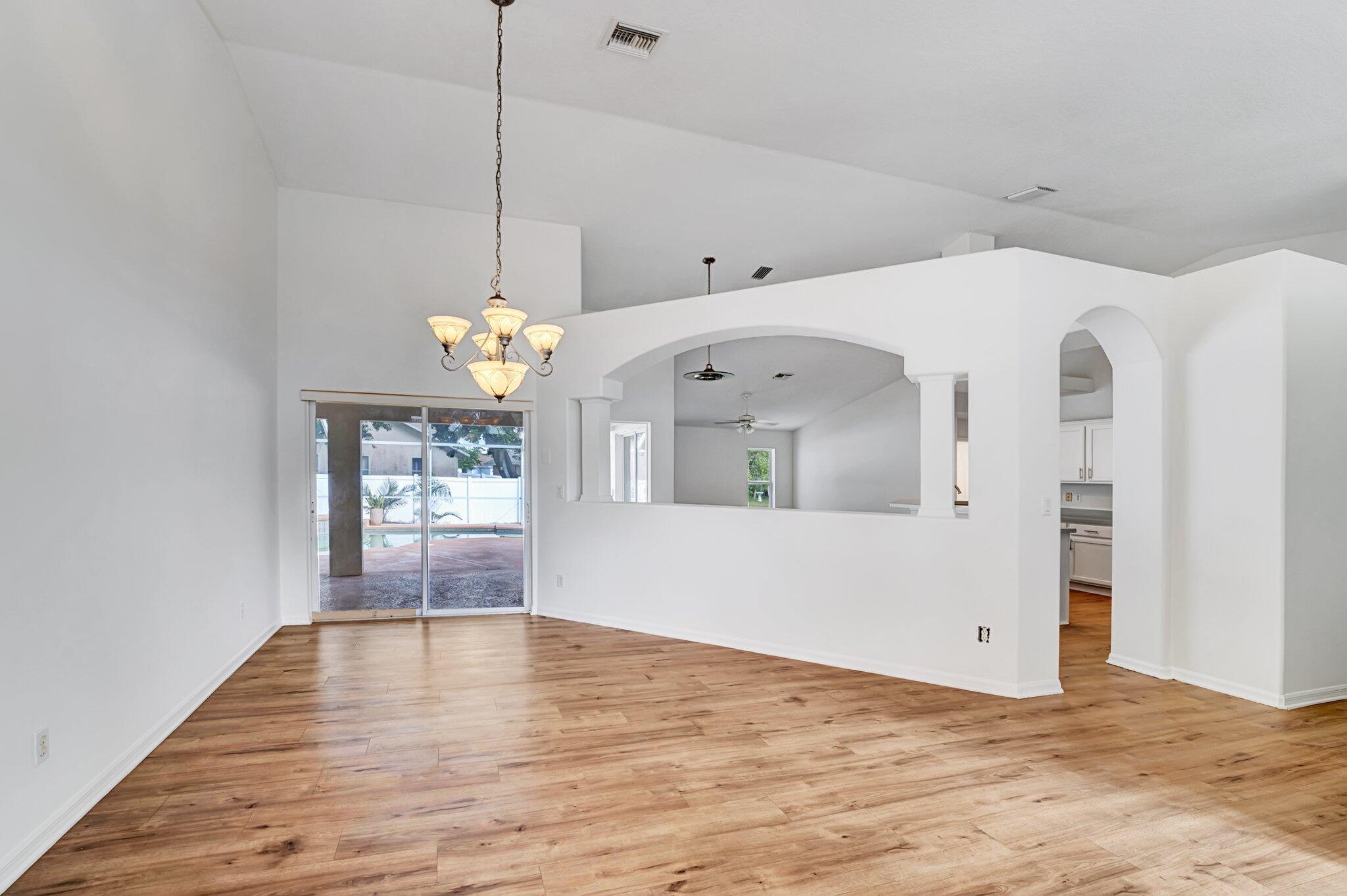 513 Southeast Cliff Road Port St. Lucie, FL 34984 - Photo 5 of 39 a view of a room with window and wooden floor
