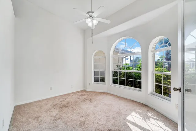 a view of a livingroom with furniture and chandelier fan