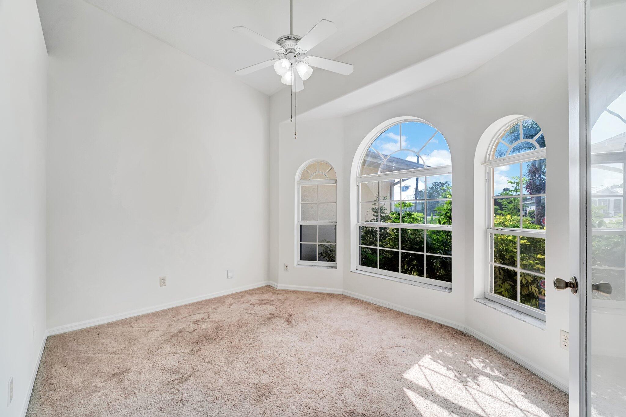 513 Southeast Cliff Road Port St. Lucie, FL 34984 - Photo 8 of 39 a view of a livingroom with furniture and chandelier fan