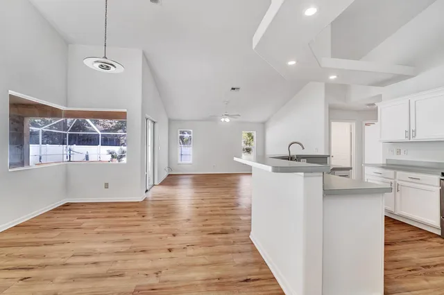a view of kitchen with sink and wooden floor