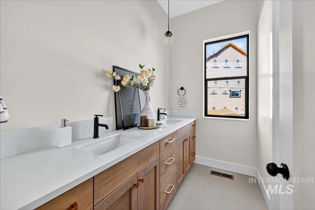 486 Joy Avenue Middleton, ID 83644 - Photo 23 of 36 Full bathroom with double vanity and light tile patterned flooring