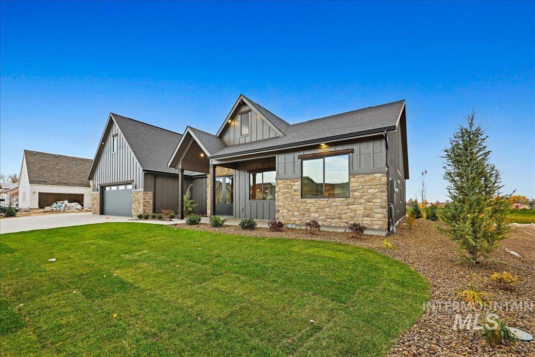 486 Joy Avenue Middleton, ID 83644 - Photo 3 of 36 Modern farmhouse style home featuring stone siding, board and batten siding, a front yard, covered porch, and driveway