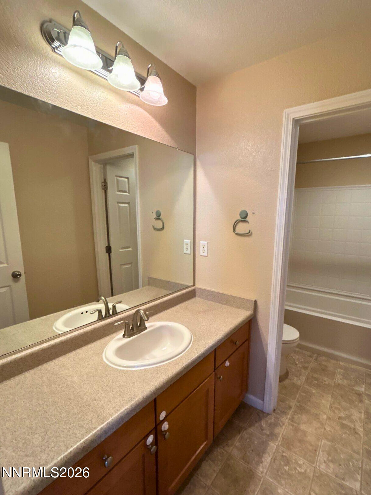 2035 Echo Valley Parkway Reno, NV 89521 - Photo 14 of 16 a bathroom with a granite countertop sink and a mirror