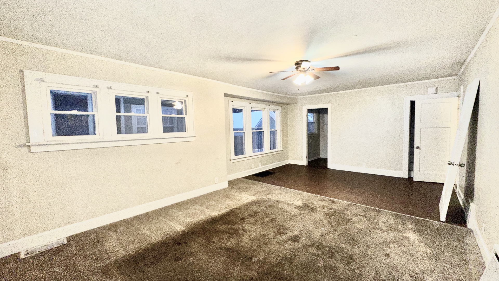 640 South Spencer Street Aurora, IL 60505 - Photo 4 of 15 a view of an empty room with chandelier fan and wooden floor