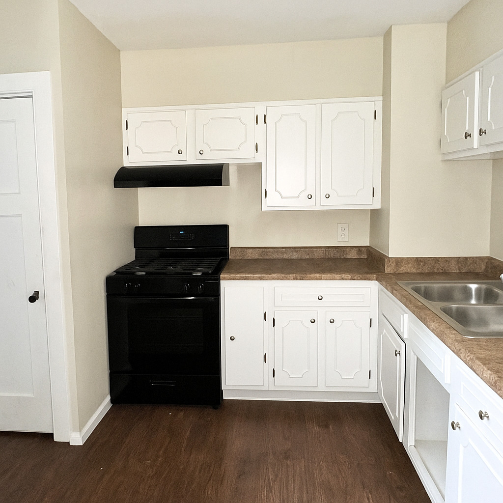 640 South Spencer Street Aurora, IL 60505 - Photo 5 of 15 a kitchen with granite countertop white cabinets and black appliances