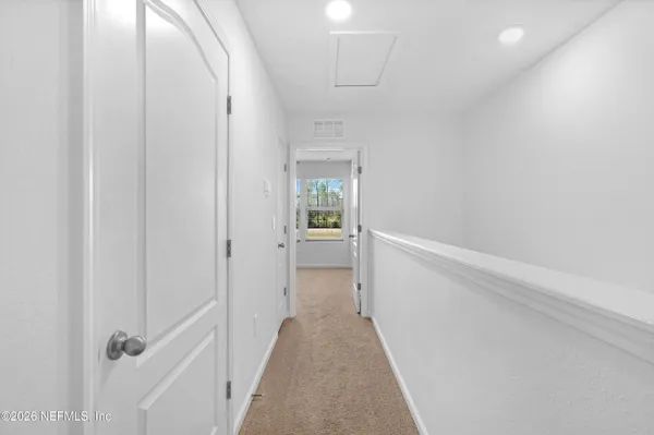 a view of a hallway with white walls