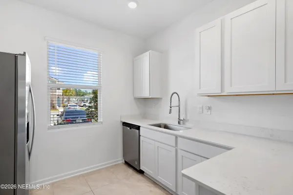 a kitchen with white cabinets and a sink