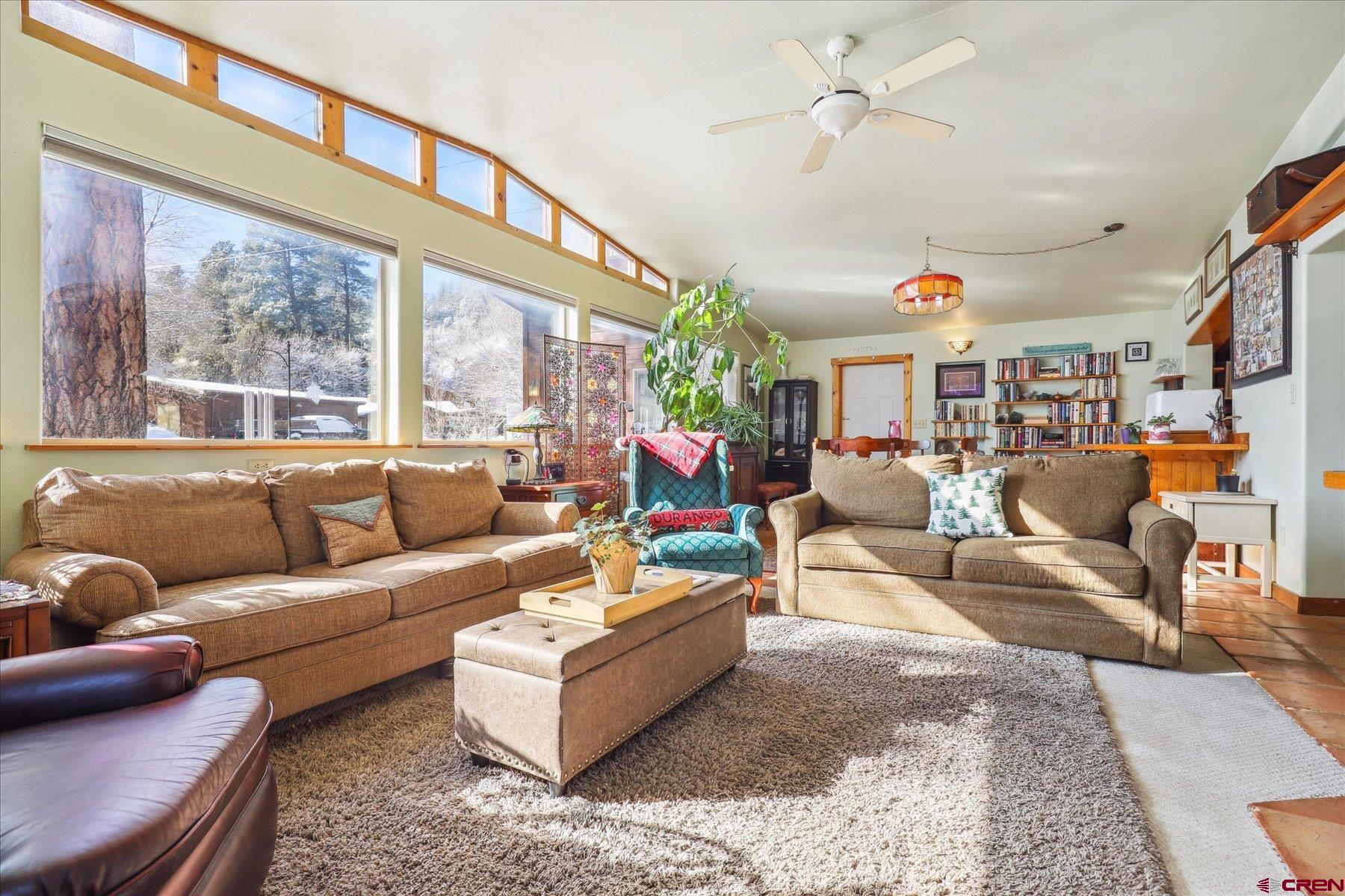 6815 County Road 203 Durango, CO 81301 - Photo 2 of 35 a living room with furniture a ceiling fan and a large window