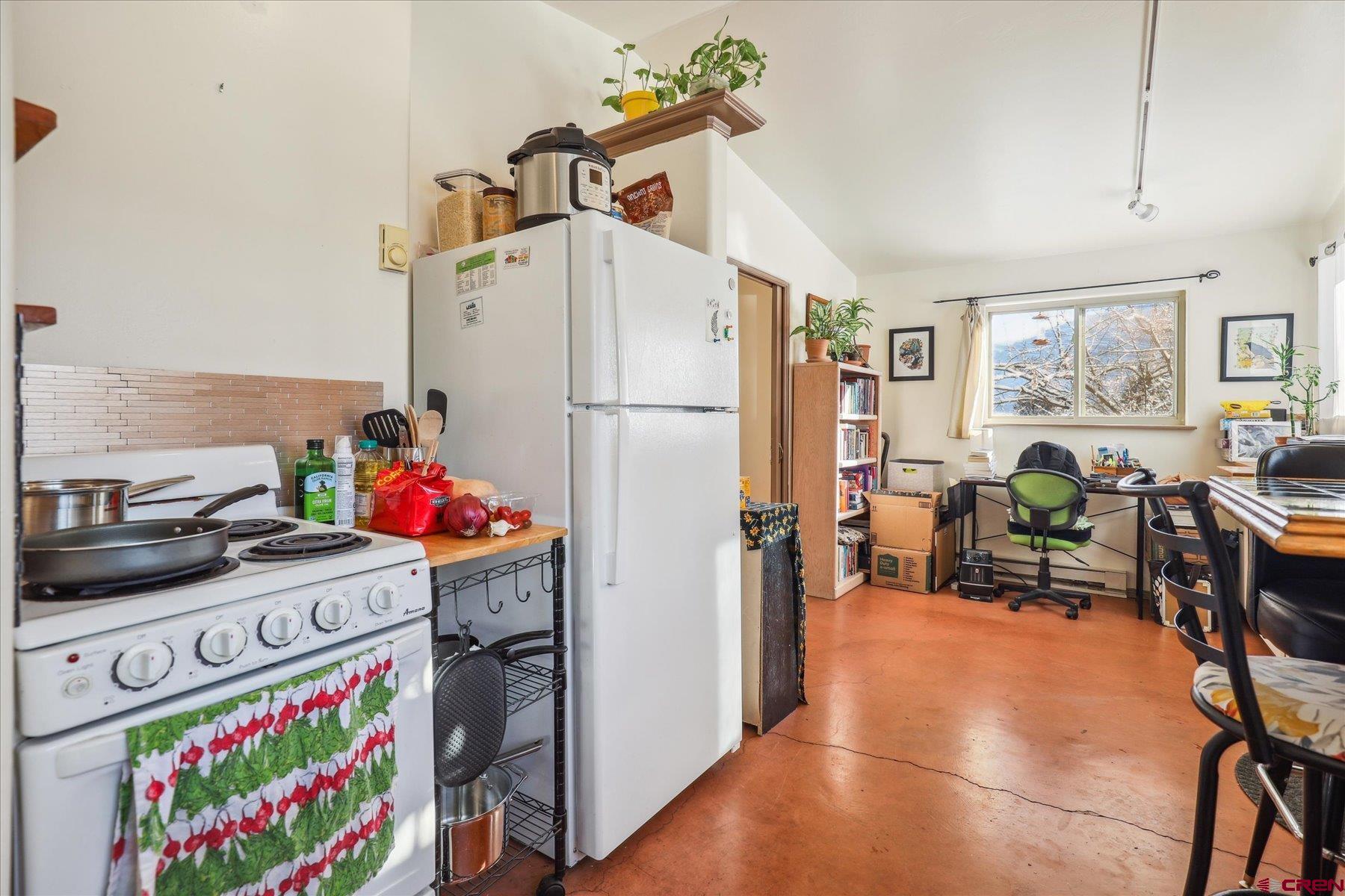 6815 County Road 203 Durango, CO 81301 - Photo 24 of 35 a kitchen with stainless steel appliances a stove a refrigerator and a refrigerator