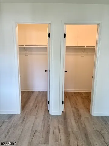 an empty room with wooden floor and a window