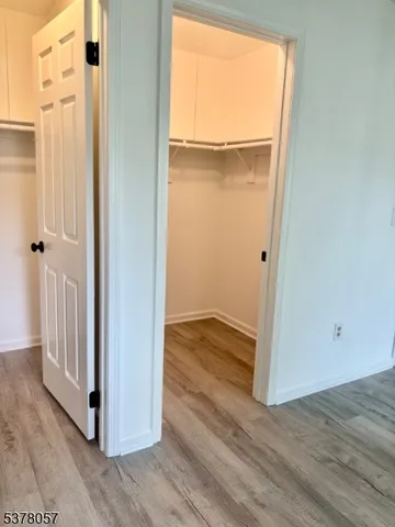 an empty room with wooden floor and a window