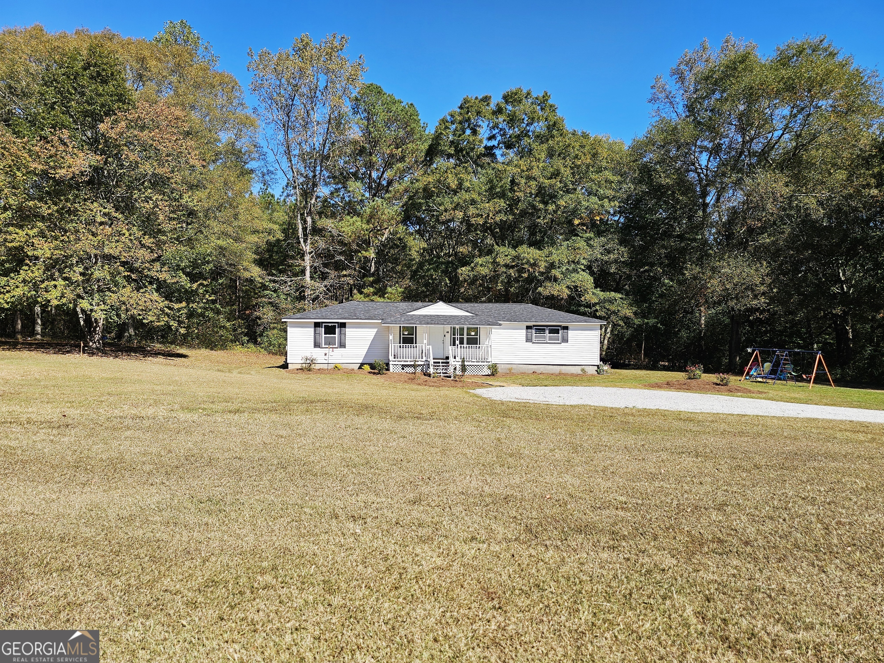 46 Gammon Road Carrollton, GA 30117 - Photo 16 of 17 a view of a house with pool and trees in the background