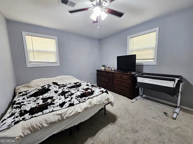 a bedroom with bed and window
