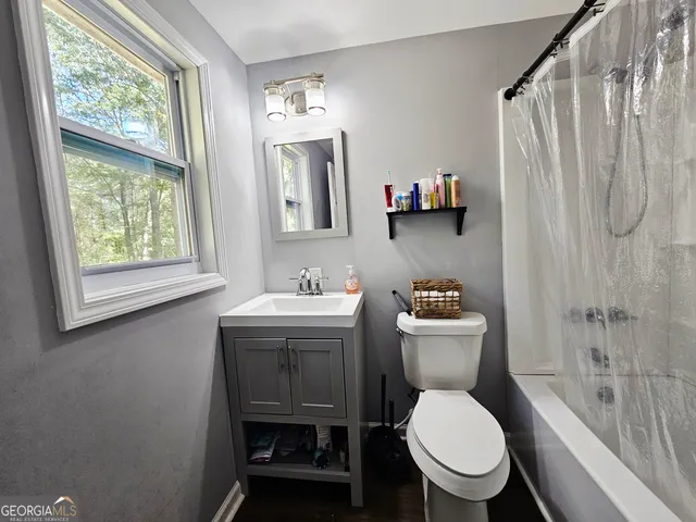 a bathroom with a toilet a sink and a shower