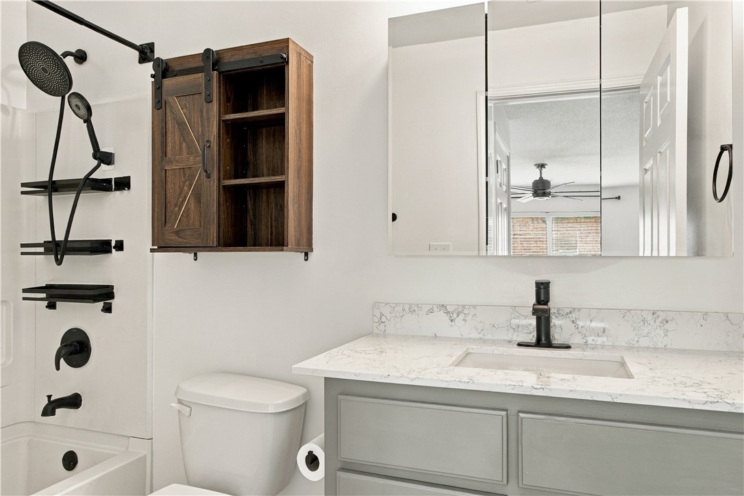 636 Lookover Drive Anderson, SC 29621 - Photo 30 of 34 Elegant stone countertops and modern black fixtures elevate this refreshed bathroom space.