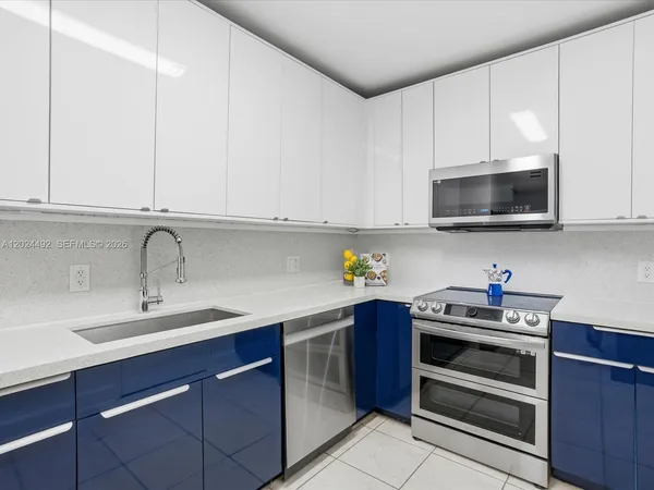 a kitchen with stainless steel appliances granite countertop a sink and a stove top oven