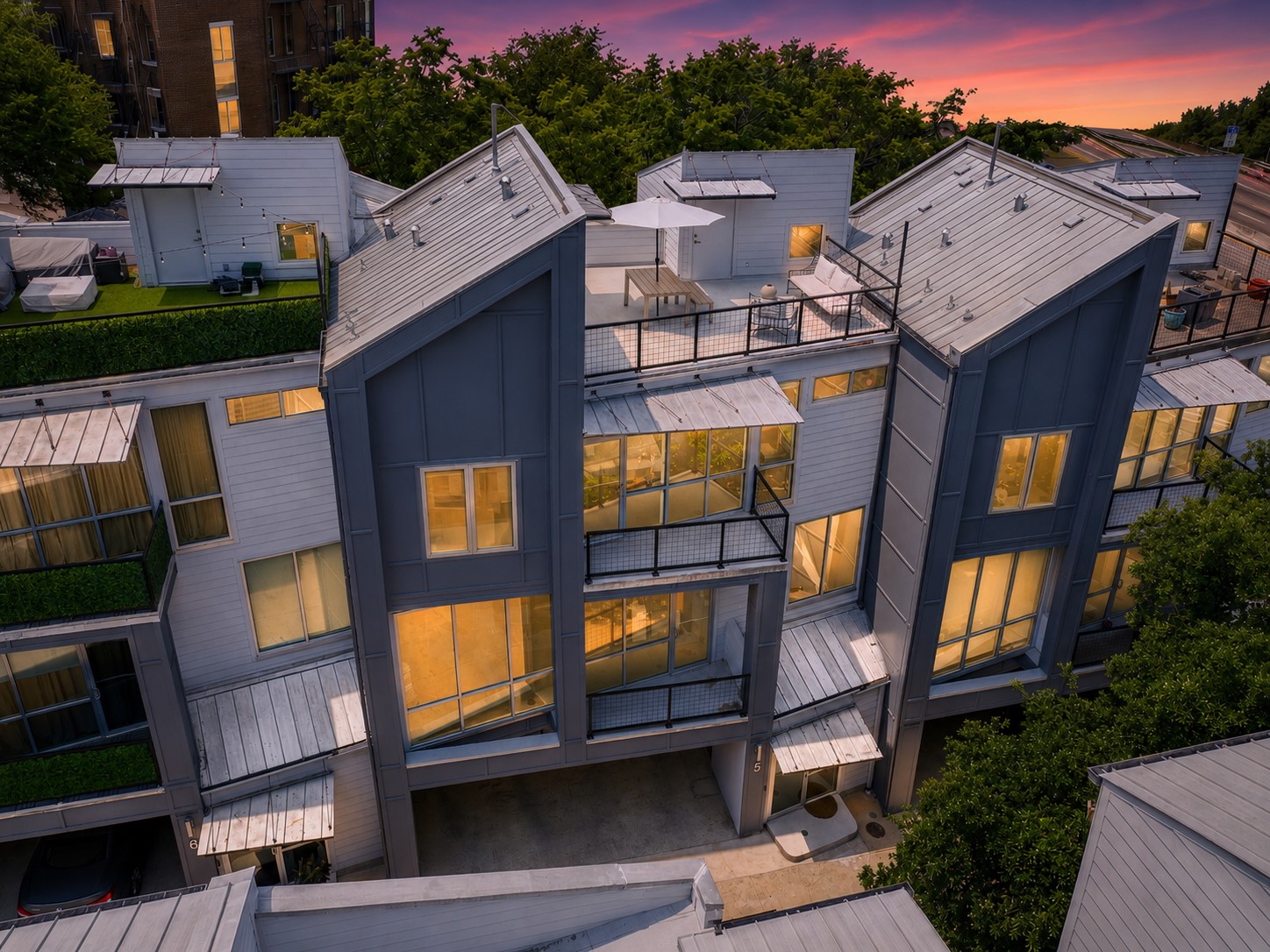 1500 Summit Street, Unit 5 Austin, TX 78741 - Photo 2 of 34 Modern townhome architecture featuring multiple balconies and a rooftop terrace