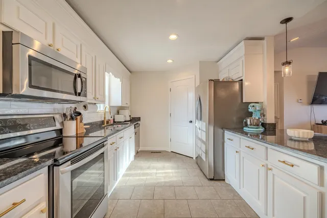 a kitchen with a sink stove and microwave