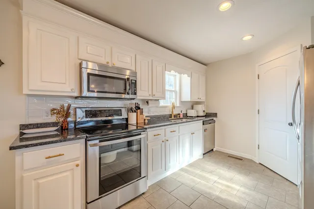 a dining room with granite countertop furniture and a chandelier