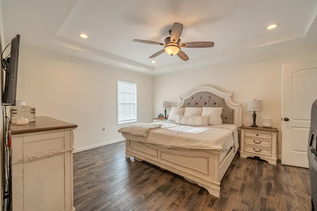 a bedroom with a bed and a chandelier