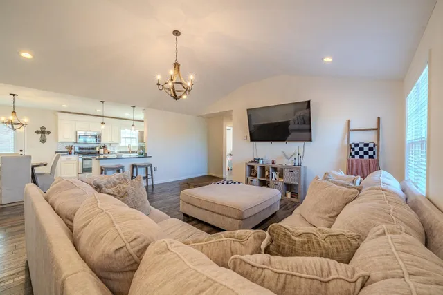 a living room with furniture and a wooden floor