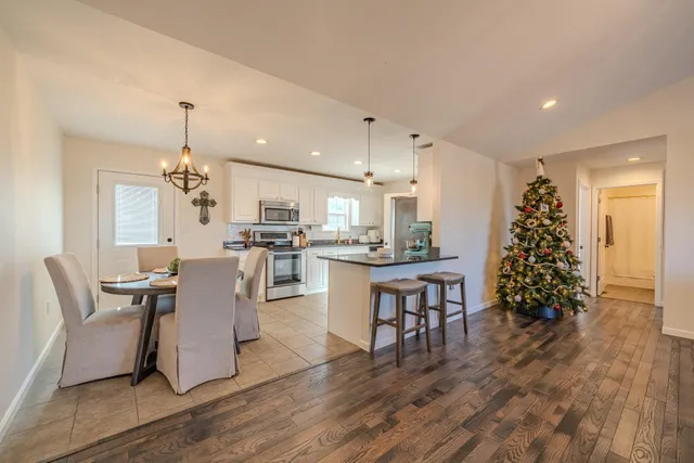 a kitchen with stainless steel appliances granite countertop a refrigerator and a stove top oven