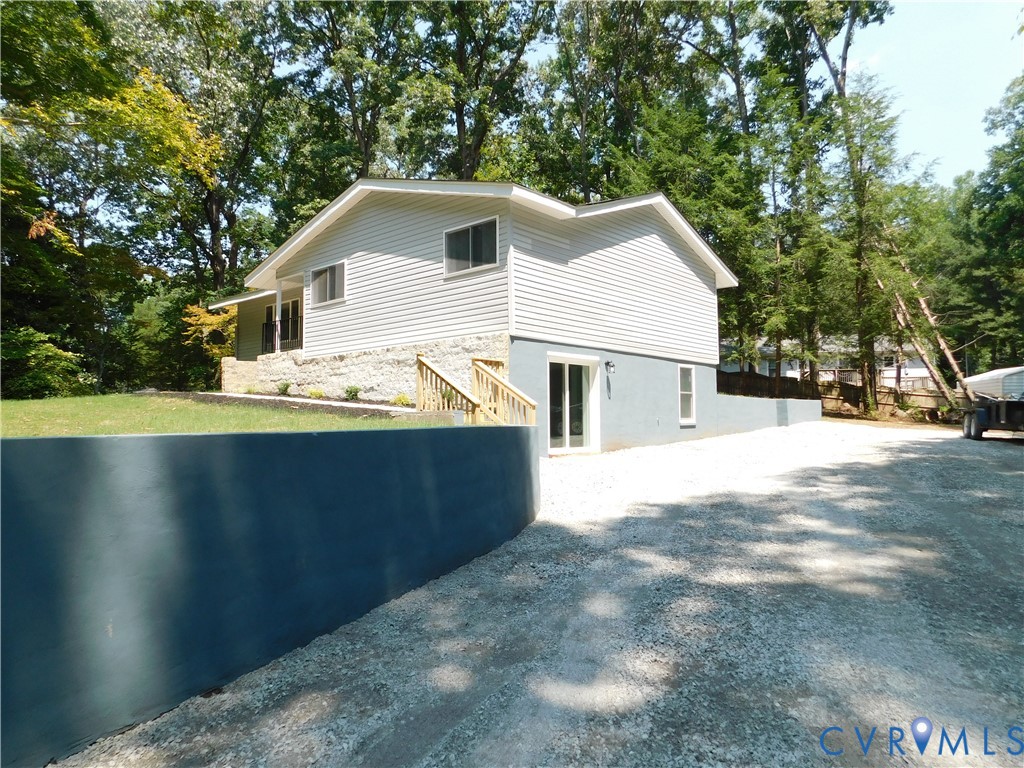 5322 Adams Road Quinton, VA 23141 - Photo 30 of 56 Grey siding exterior with stone accent, gravel dri