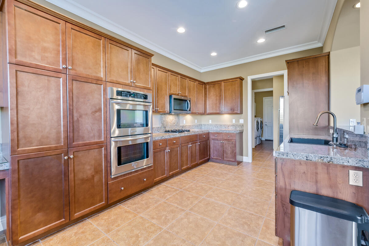 112 Rosetta Court Palm Desert, CA 92211 - Photo 11 of 41 a kitchen with a refrigerator sink and cabinets