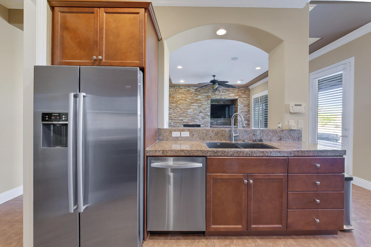 112 Rosetta Court Palm Desert, CA 92211 - Photo 13 of 41 a kitchen with stainless steel appliances granite countertop a refrigerator and a sink