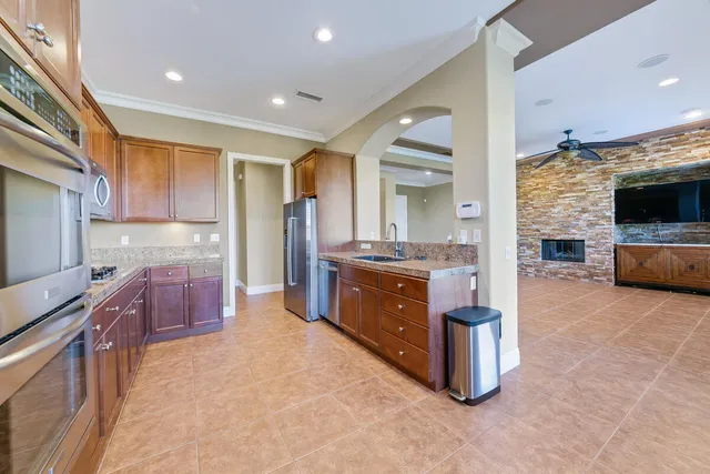 a kitchen with granite countertop cabinets and window