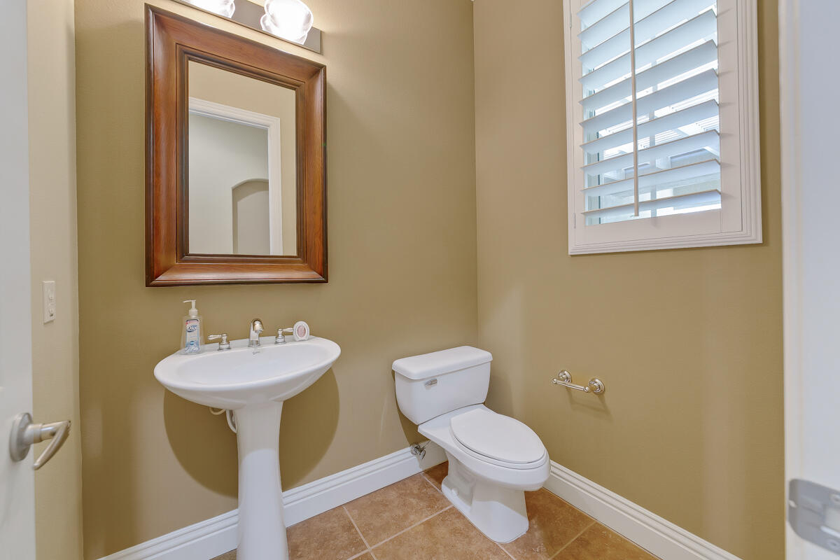 112 Rosetta Court Palm Desert, CA 92211 - Photo 30 of 41 a bathroom with a toilet sink and mirror