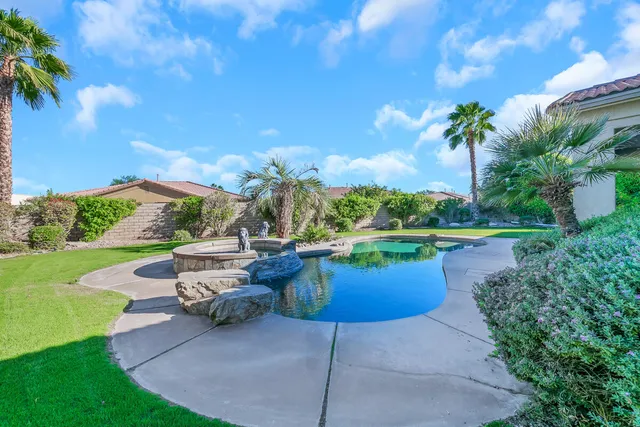 a view of a house with swimming pool and a yard