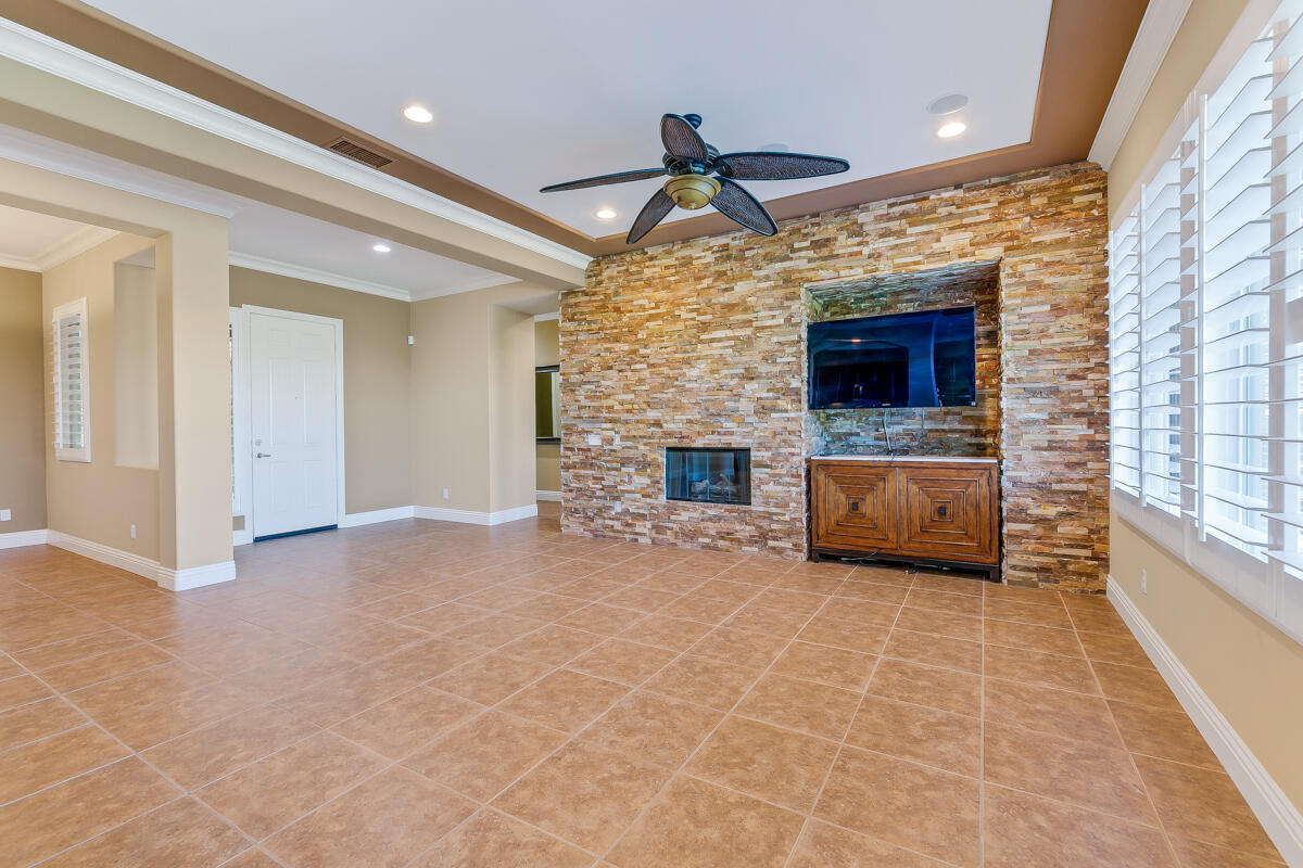 112 Rosetta Court Palm Desert, CA 92211 - Photo 6 of 41 a view of empty room with fireplace and windows