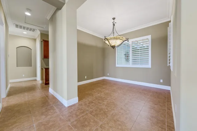 an entryway with wooden floor and a window