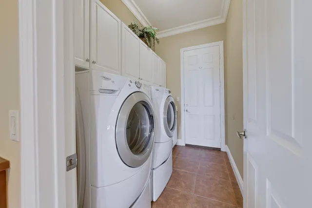 a kitchen with a refrigerator sink and cabinets