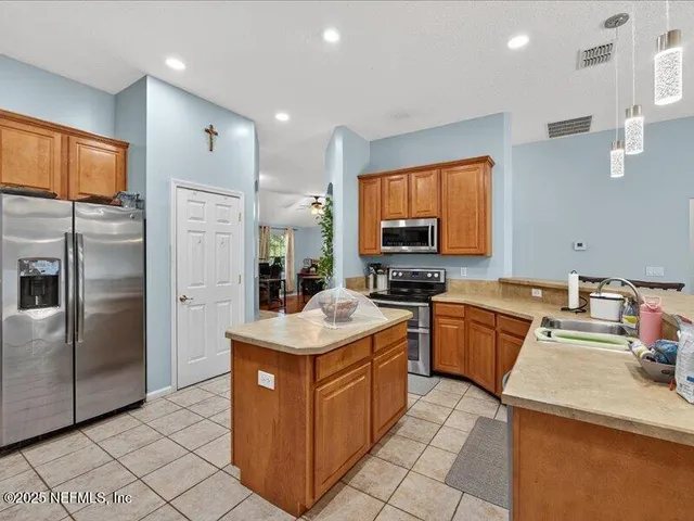 a kitchen with a sink stove and refrigerator