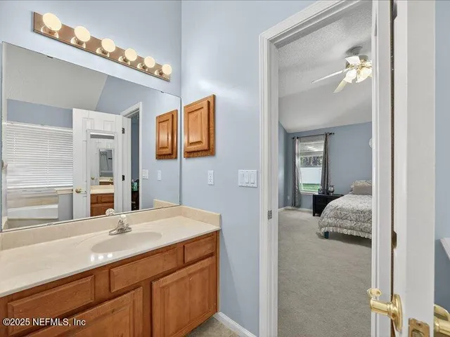a en suite bathroom with a sink double vanity and mirror