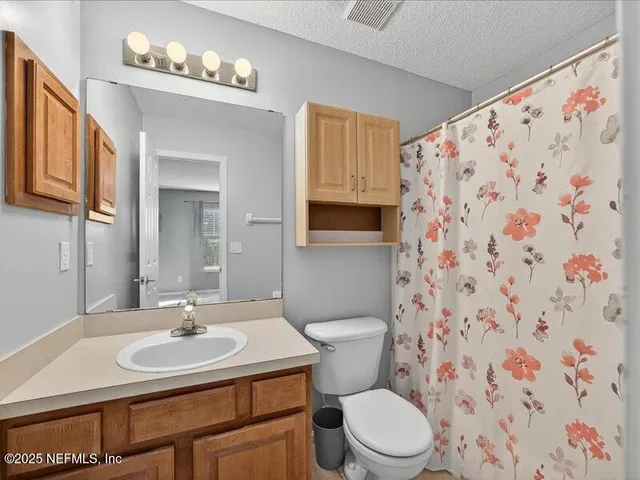 a bathroom with a sink toilet and mirror