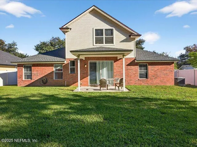 a front view of a house with a yard porch and outdoor seating