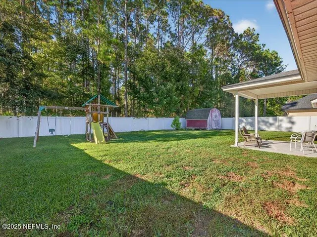 a view of a backyard with a swimming pool
