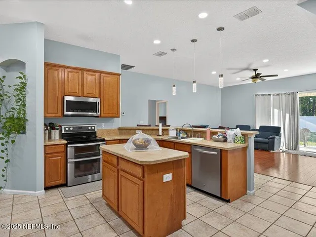 a kitchen with a sink stove and microwave
