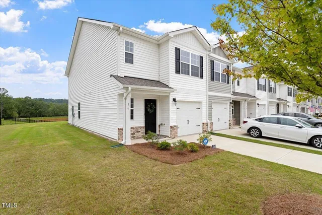 a view of a white house with a yard