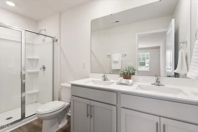 a bathroom with a sink toilet and shower