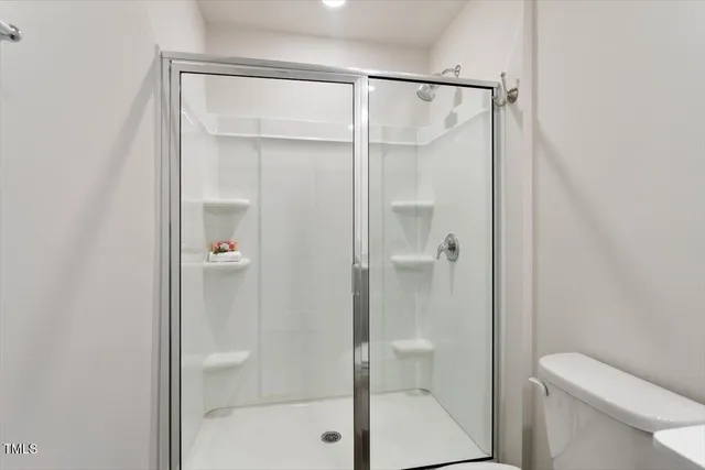 a bathroom with a shower and a toilet