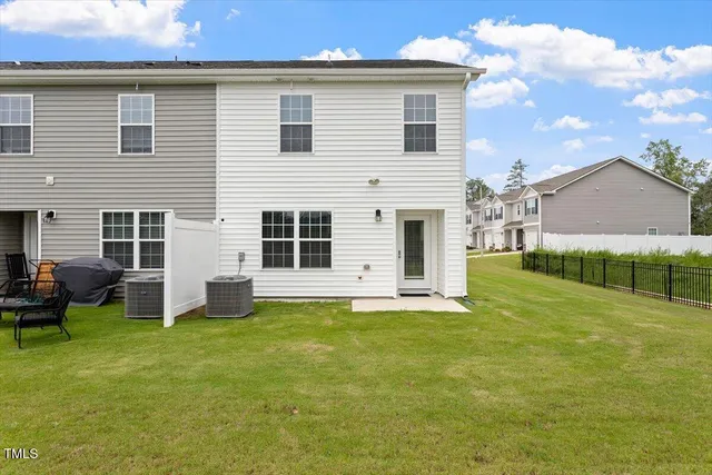 a view of a house with a yard and sitting area