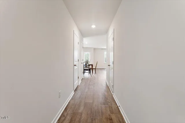 a view of a hallway with wooden floor