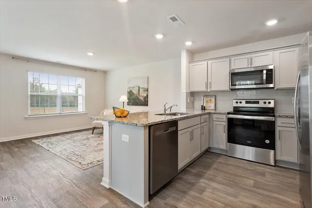 a kitchen with a sink microwave and refrigerator
