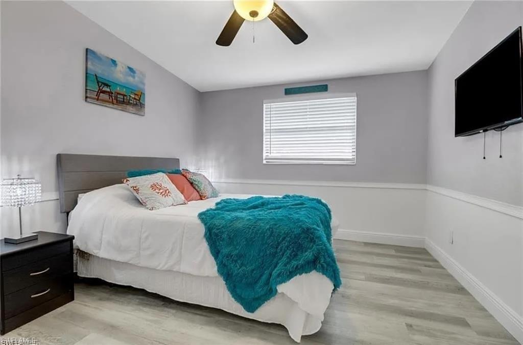 2047 Harbor Lane Naples, FL 34104 - Photo 11 of 27 Bedroom with light wood-style floors and a ceiling fan