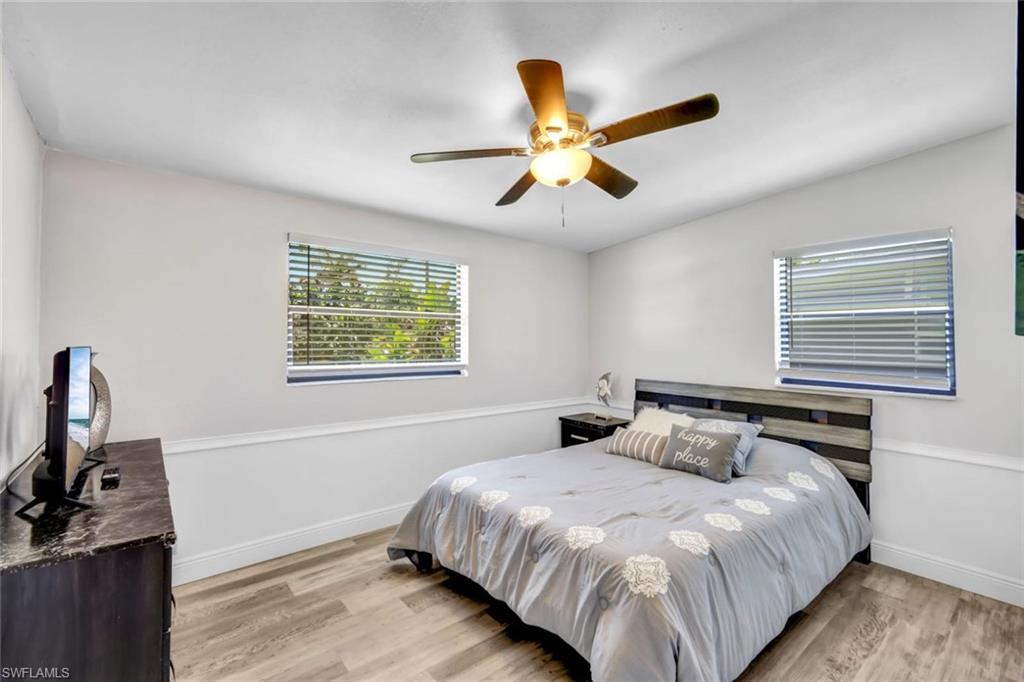 2047 Harbor Lane Naples, FL 34104 - Photo 13 of 27 Bedroom featuring light wood-style floors and ceiling fan
